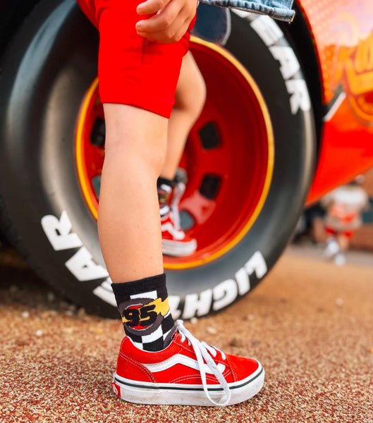 Checkered socks with racing-themed design on a white background - Ledger Nash Co - Model 2