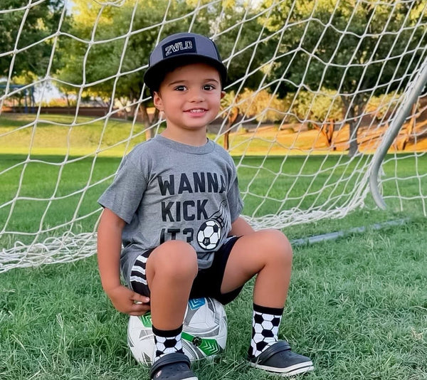 Wanna Kick It Kids Soccer Tee - Model1 - Ledger Nash Co